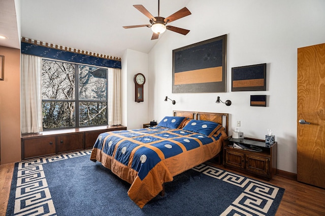 bedroom with ceiling fan, lofted ceiling, and dark hardwood / wood-style floors