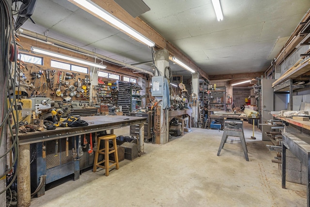 misc room featuring a workshop area and concrete flooring