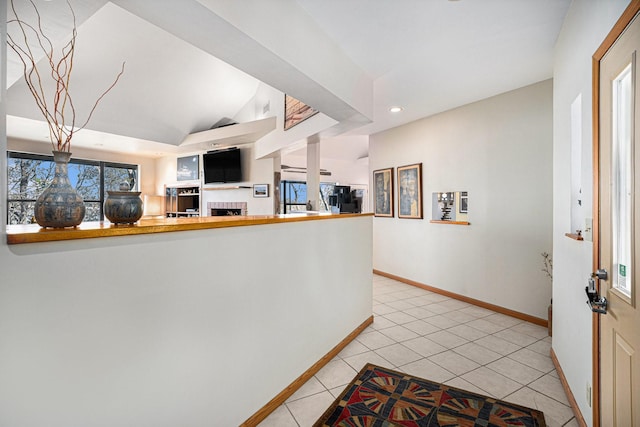 kitchen featuring light tile patterned floors, lofted ceiling, and kitchen peninsula