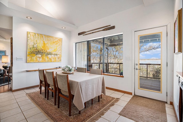 tiled dining area with lofted ceiling