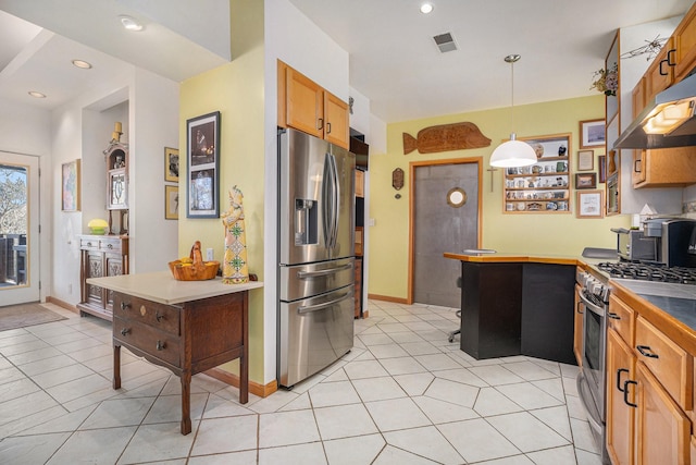 kitchen featuring decorative light fixtures, light tile patterned floors, and stainless steel appliances