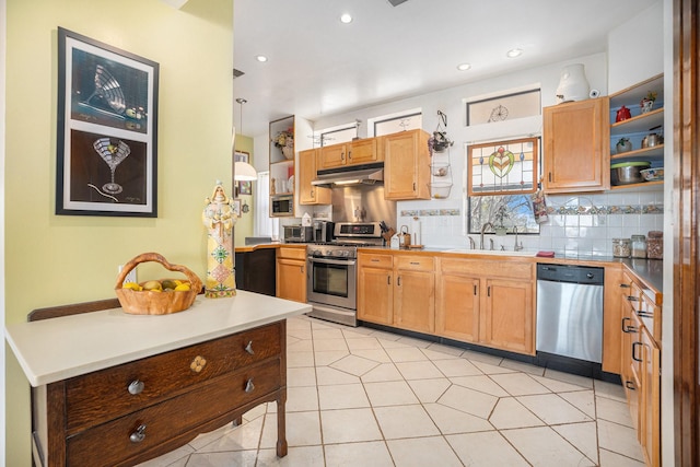 kitchen featuring light tile patterned floors, sink, backsplash, and appliances with stainless steel finishes