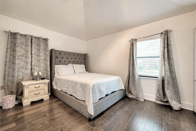 bedroom featuring vaulted ceiling and dark hardwood / wood-style floors