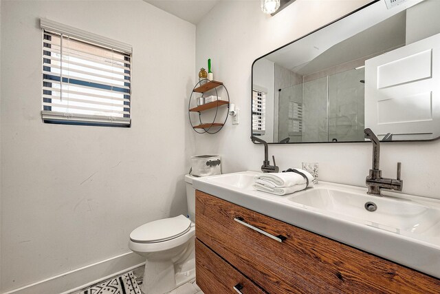 bathroom featuring tile patterned floors, an enclosed shower, vanity, and toilet