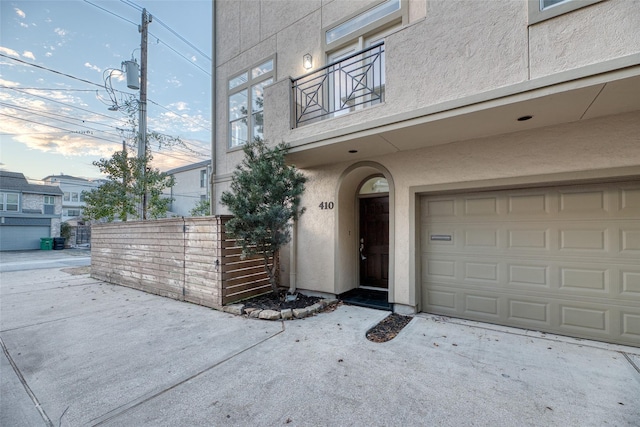 doorway to property with a balcony and a garage