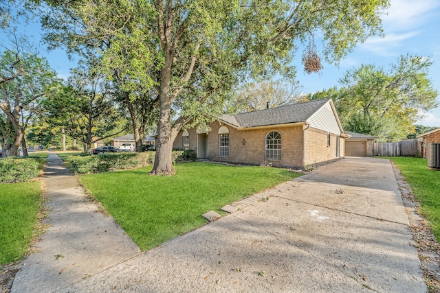 single story home featuring a front lawn and a garage