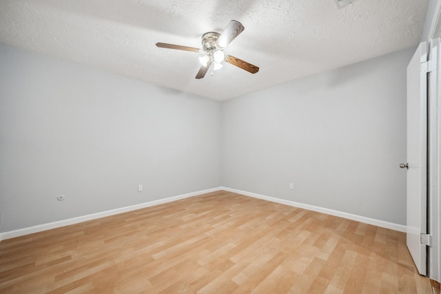 spare room featuring light hardwood / wood-style floors, a textured ceiling, and ceiling fan