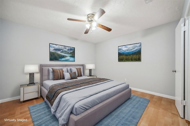 bedroom featuring ceiling fan and light hardwood / wood-style floors