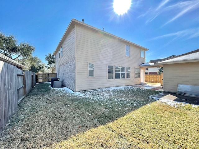 rear view of house with a yard and a patio area