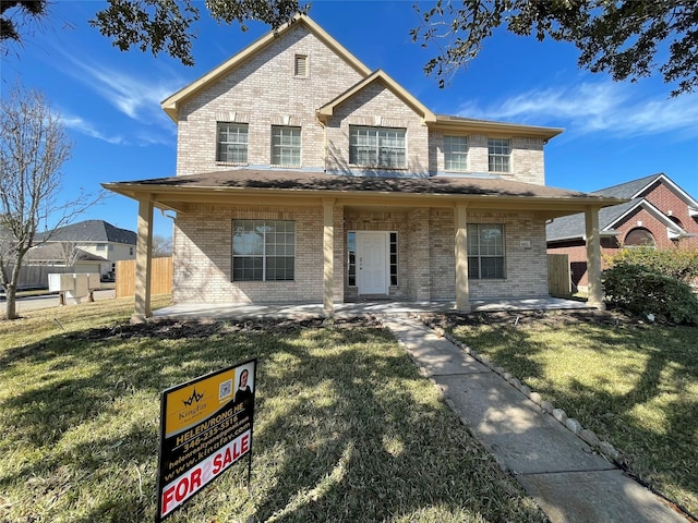 view of front of house featuring a front yard and a patio