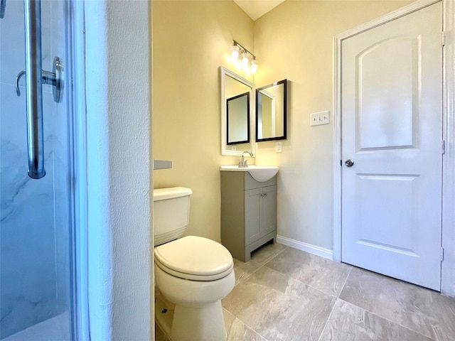 bathroom with vanity, toilet, and a shower with shower door