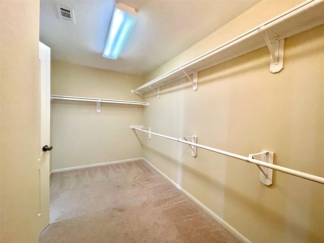 spacious closet with carpet and visible vents