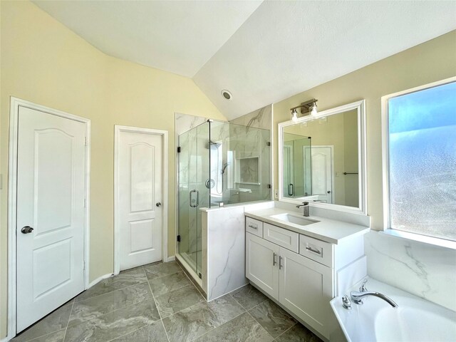 bathroom with vanity, vaulted ceiling, and separate shower and tub