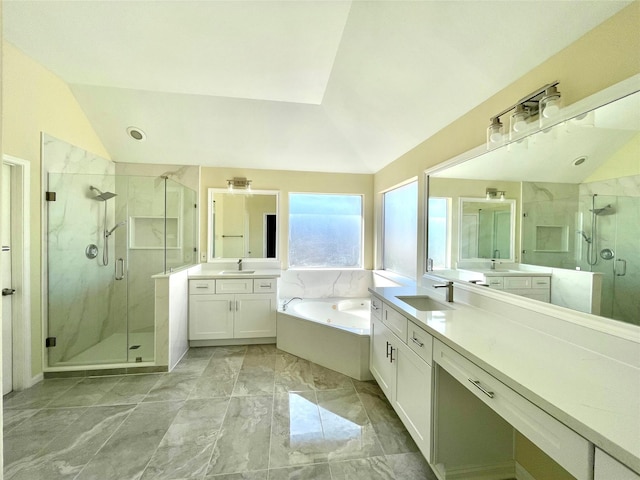 bathroom featuring vaulted ceiling, shower with separate bathtub, and vanity