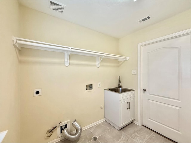 clothes washing area featuring cabinets, washer hookup, sink, and electric dryer hookup