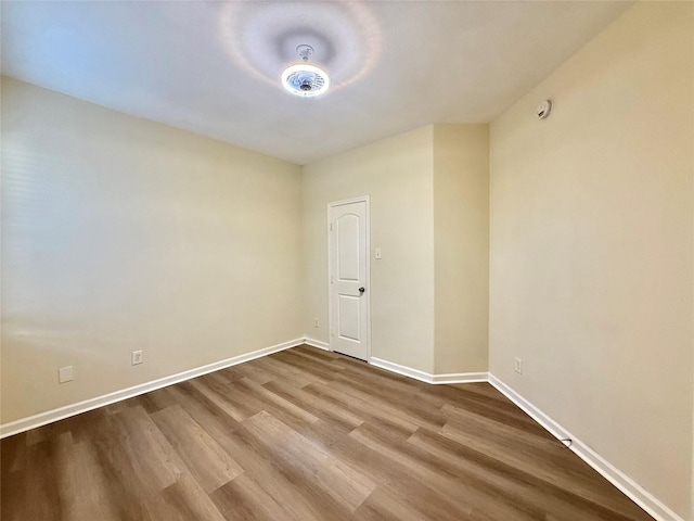 empty room featuring baseboards and wood finished floors