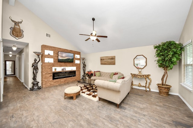 living room with ceiling fan, wood-type flooring, and vaulted ceiling