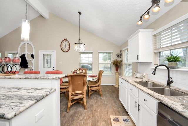 kitchen with hardwood / wood-style flooring, sink, white cabinetry, and stainless steel dishwasher