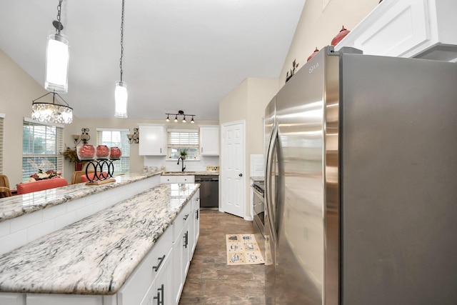 kitchen featuring decorative light fixtures, vaulted ceiling, white cabinetry, light stone countertops, and stainless steel appliances