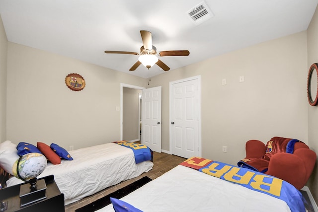 bedroom featuring dark wood-type flooring and ceiling fan