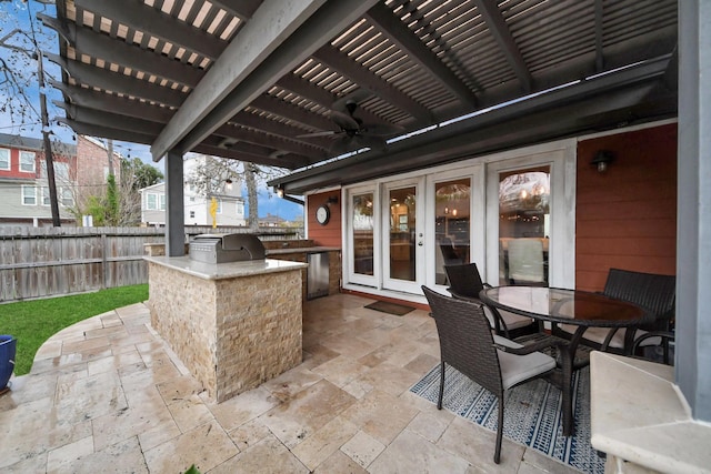 view of patio with a pergola, a grill, french doors, and exterior kitchen