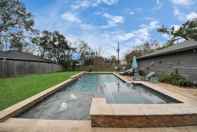 view of pool with pool water feature, a patio area, and a yard