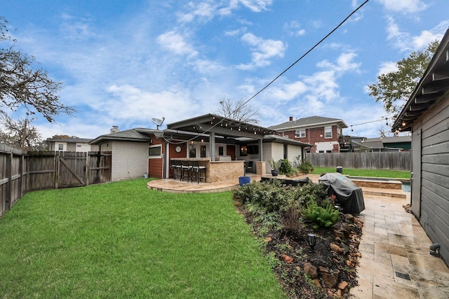 back of house with a patio area, an outdoor bar, and a yard