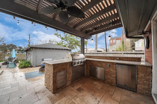 view of patio featuring ceiling fan, an outdoor kitchen, grilling area, and a pergola