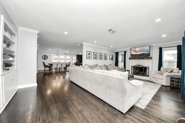 living room featuring dark hardwood / wood-style flooring and ornamental molding