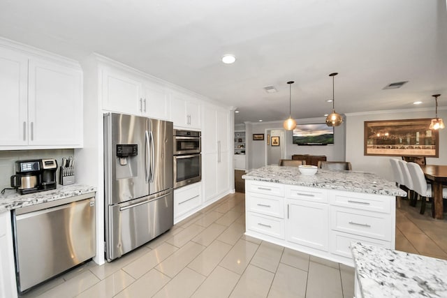 kitchen with white cabinets, stainless steel appliances, and pendant lighting