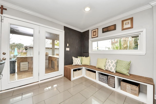 mudroom featuring plenty of natural light, ornamental molding, and light tile patterned flooring