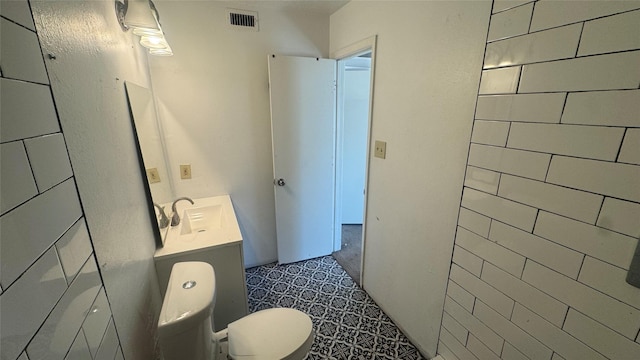 bathroom featuring toilet and vanity