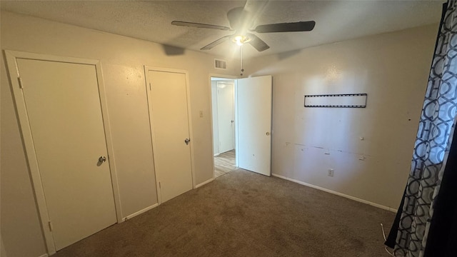 unfurnished bedroom featuring ceiling fan, a textured ceiling, and carpet floors