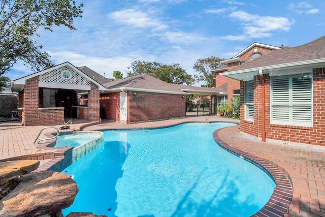 view of pool with an in ground hot tub and a patio