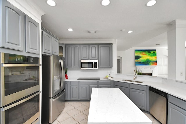 kitchen featuring kitchen peninsula, sink, gray cabinetry, stainless steel appliances, and light tile patterned floors