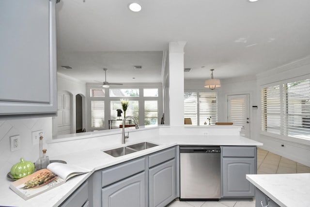 kitchen with gray cabinets, stainless steel dishwasher, decorative backsplash, kitchen peninsula, and sink