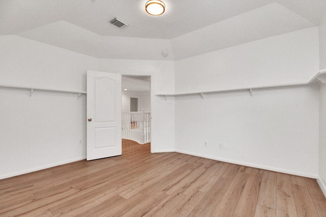 spacious closet with light hardwood / wood-style flooring