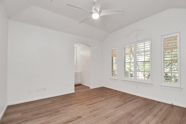 spare room featuring vaulted ceiling, ceiling fan, and light hardwood / wood-style flooring