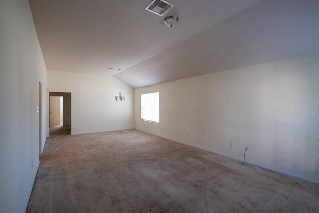 carpeted empty room with a chandelier and lofted ceiling