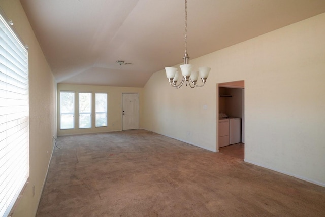 interior space with lofted ceiling, washer and clothes dryer, and a chandelier