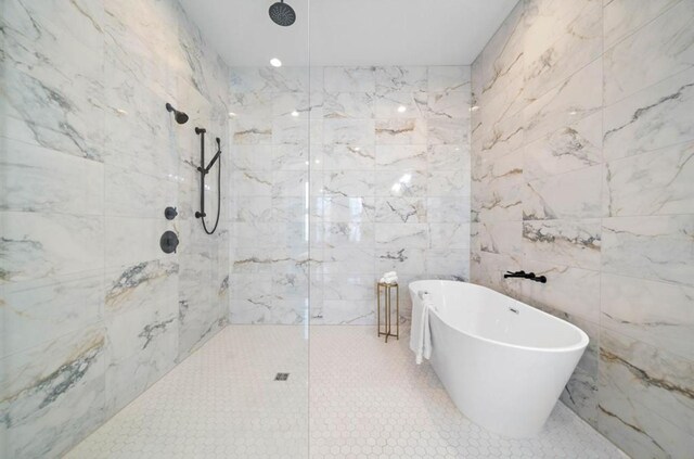 bathroom featuring tile walls, tile patterned flooring, and plus walk in shower