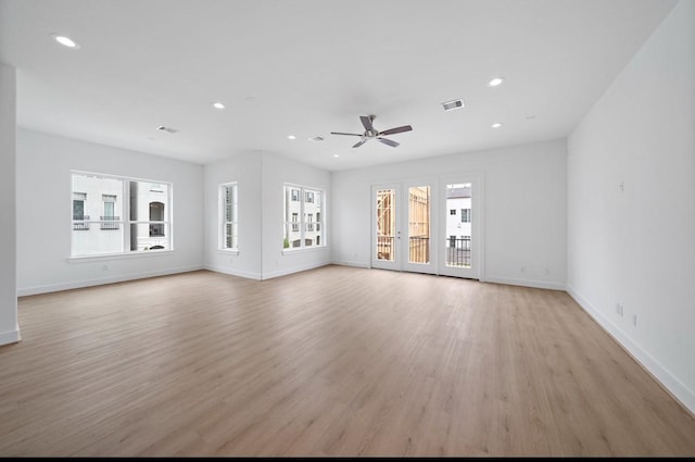 unfurnished living room with ceiling fan and light hardwood / wood-style floors