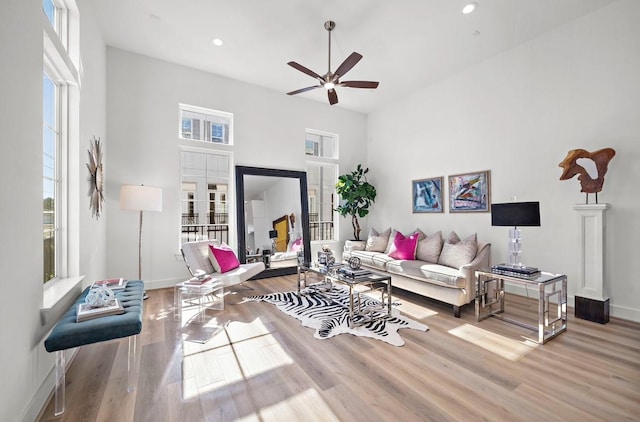 living room featuring ceiling fan and light hardwood / wood-style flooring