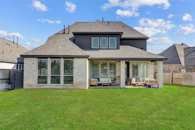 rear view of house featuring an outdoor hangout area, a patio area, and a yard