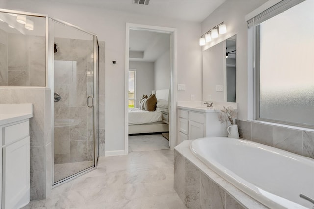 bathroom featuring vanity and independent shower and bath