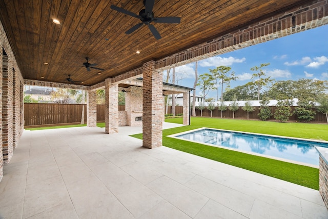 view of pool with a yard, a patio area, and ceiling fan