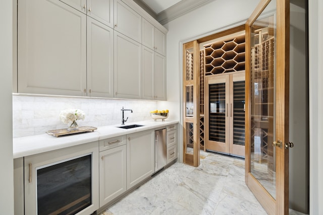 bar with tasteful backsplash, sink, stainless steel dishwasher, and ornamental molding