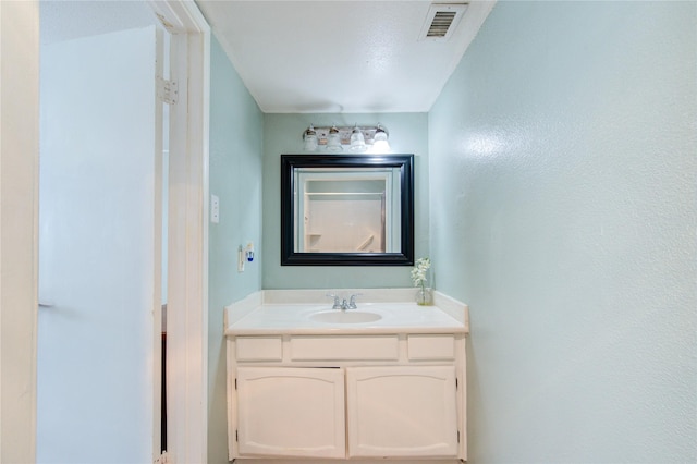 bathroom with vanity and a textured ceiling