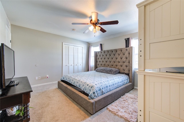 bedroom featuring ceiling fan, a closet, and light carpet