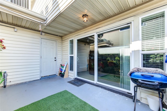 view of exterior entry featuring a patio area